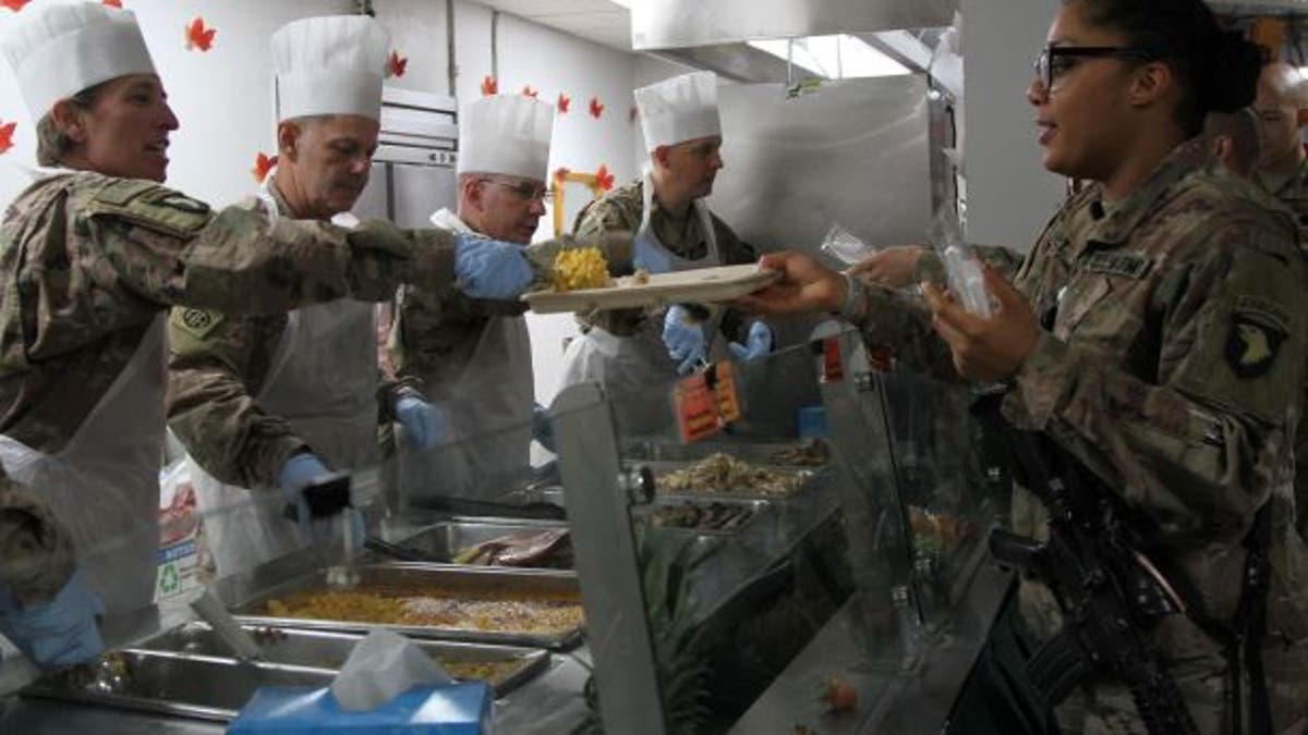 soldier gets a scoop of macaroni and cheese as part of the 2018 Thanksgiving meal at the Koele Dining Facility at the Bagram Airfield in Afghanistan. While this year’s Thanksgiving meal may look different this year, the Defense Logistics Agency Troop Support has been providing traditional Thanksgiving food to field kitchens, dining facilities and galleys to locations in the United States and around the world. (Courtesy photo)