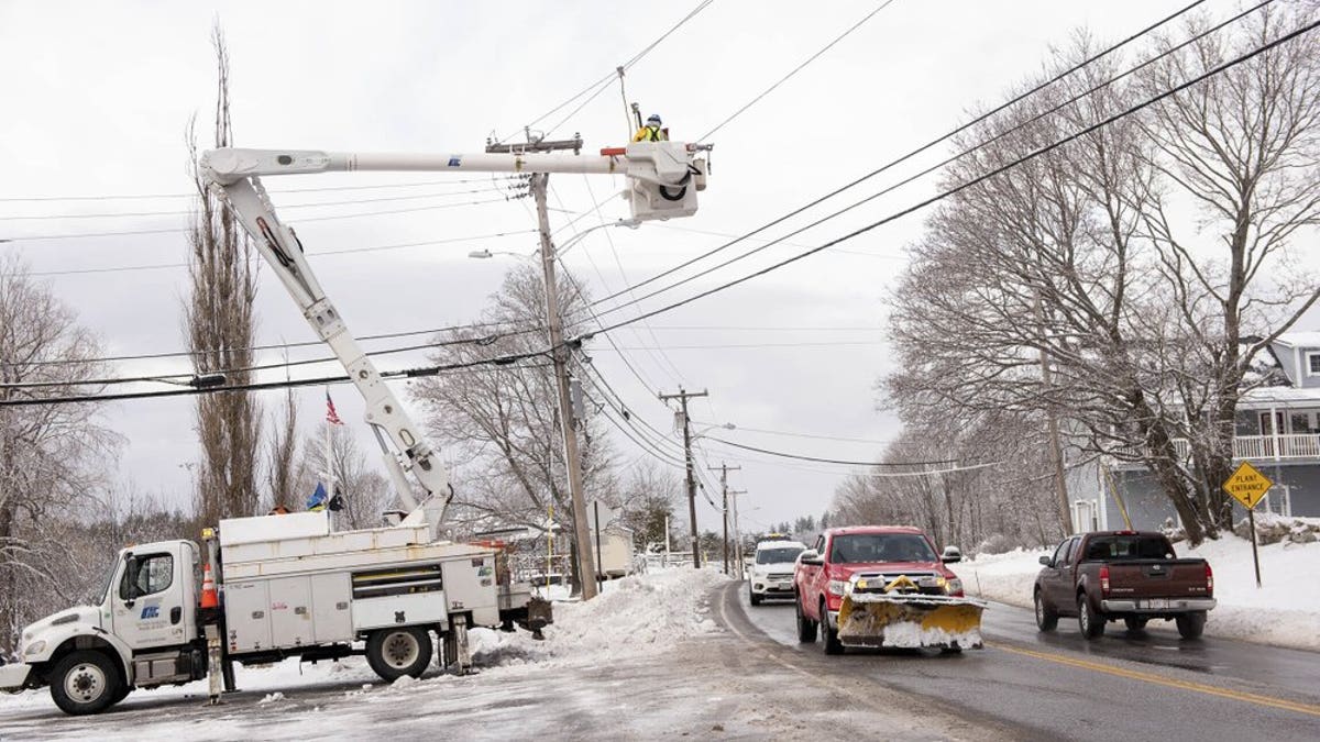 Utility crews work to restore power Sunday, Dec. 6, 2020, on Main Street in Greenwood, Maine. (Andree Kehn/Sun Journal via AP)