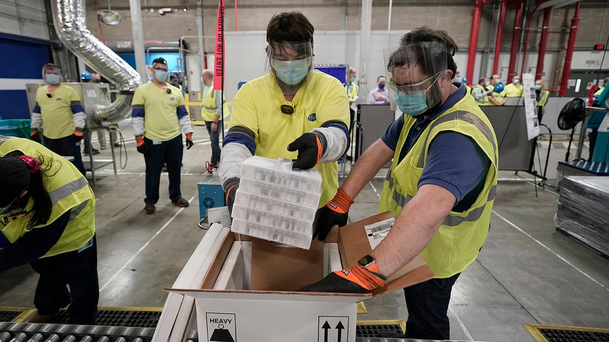 Boxes containing the Pfizer-BioNTech COVID-19 vaccine are prepared to be shipped at the Pfizer Global Supply Kalamazoo manufacturing plant in Portage, Mich., Sunday, Dec. 13, 2020. (AP Photo/Morry Gash, Pool)