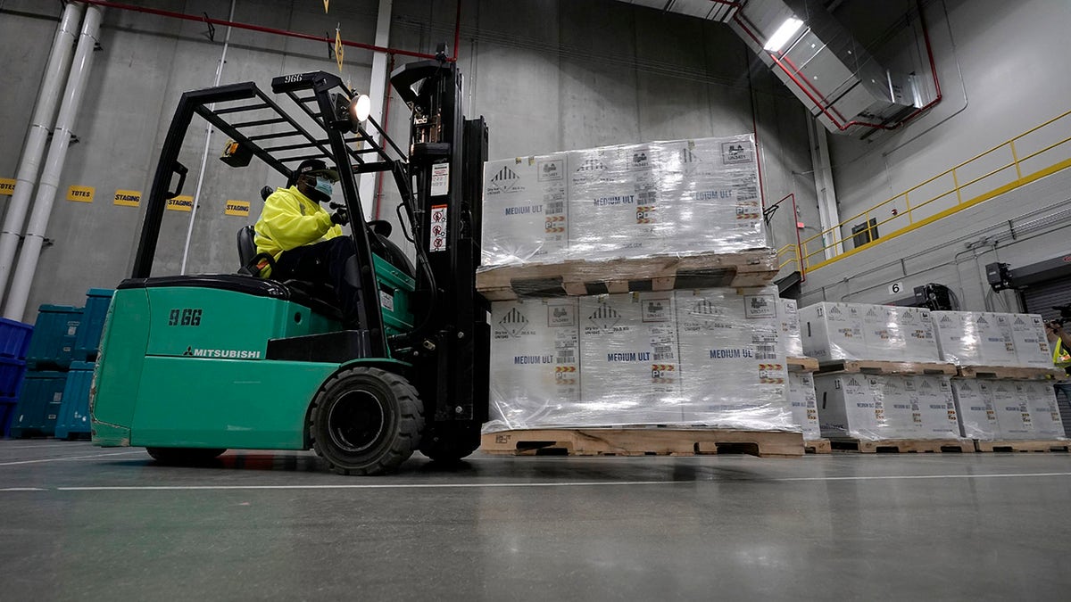 Boxes containing the Pfizer-BioNTech COVID-19 vaccine are moved to the loading dock for shipping at the Pfizer Global Supply Kalamazoo manufacturing plant in Portage, Mich., Sunday, Dec. 13, 2020.