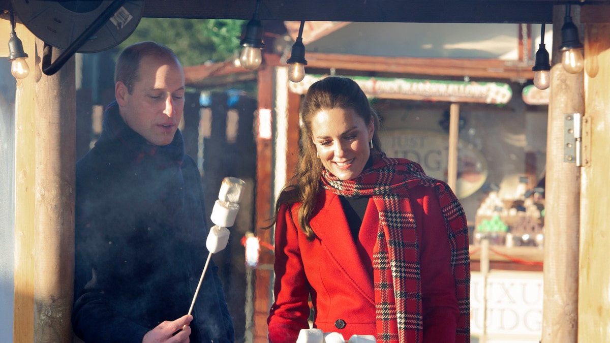 Britain's Prince William and Kate, Duchess of Cambridge toast marshmallows during a visit to meet students at the 'Christmas at the Castle' event held at Cardiff Castle, Wales, Tuesday Dec. 8, 2020.