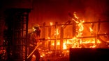 A firefighter battles the Bond Fire burning in Orange County, Calif., on Thursday, Dec. 3, 2020. (AP Photo/Noah Berger)