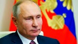 Russian President Vladimir Putin delivers his New Year address to members of the government, via teleconference call, at the Novo-Ogaryovo state residence outside Moscow, Russia, Thursday, Dec. 24, 2020. (Mikhail Klimentyev, Sputnik, Kremlin Pool Photo via AP)