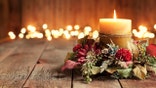 Christmas holiday elegant candle set against Christmas lights and old textured and toned wood background