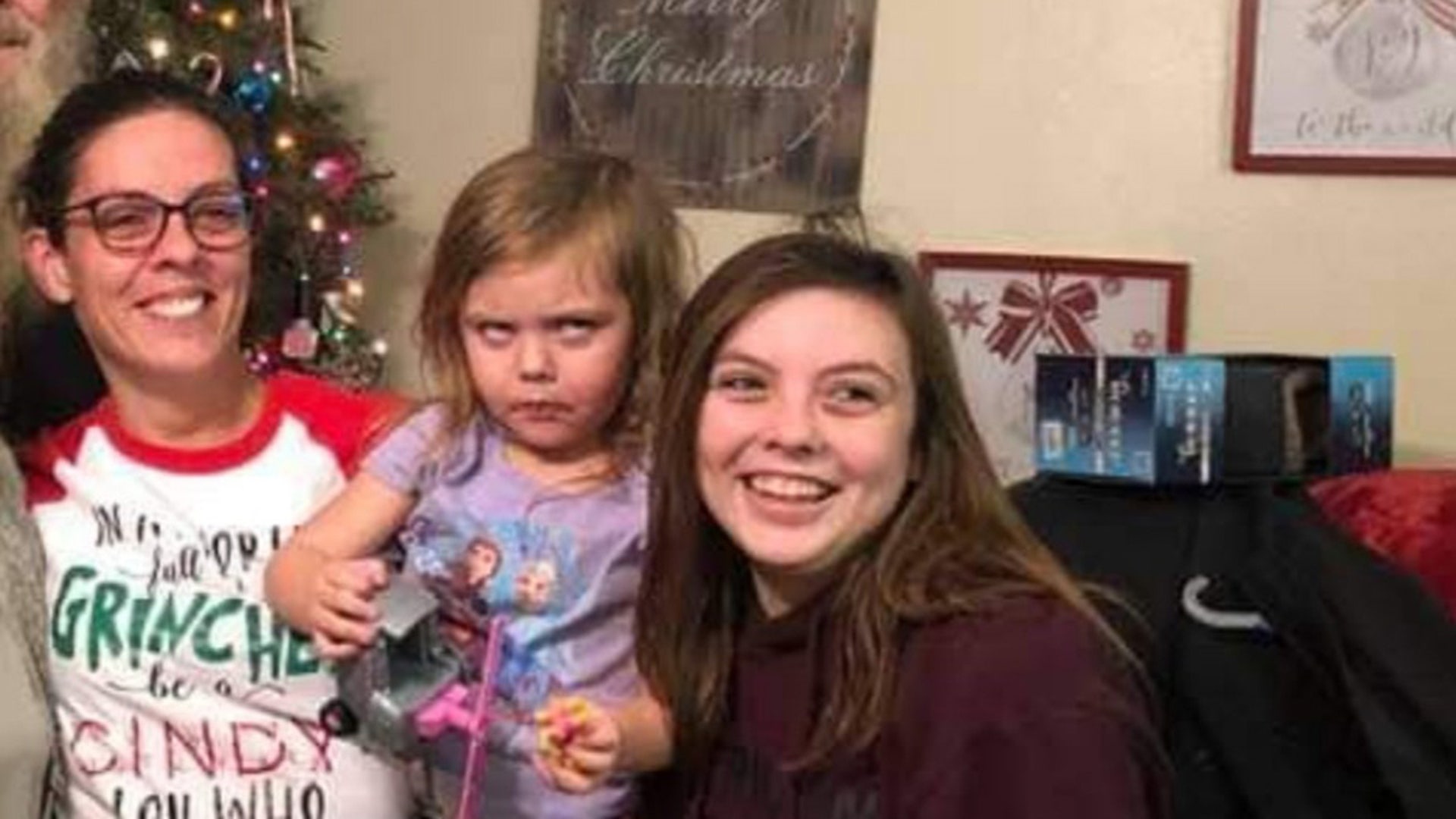 When 3 year old Preslee Ohliger of Abilene, Texas (center) had to stop playing with her news toys to pose for this photo, her frustration was highly visible. At least her mom (left) and sister, Lilee (right) were happy to stop for a photo op.
