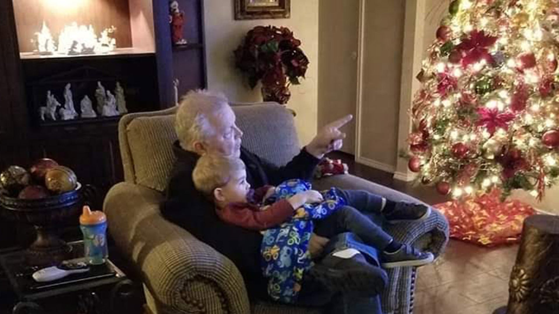 In Fort Worth, Texas Grandpa Bud Holladay explains the story behind treasured family Christmas ornaments to grandson Brody Lewis.