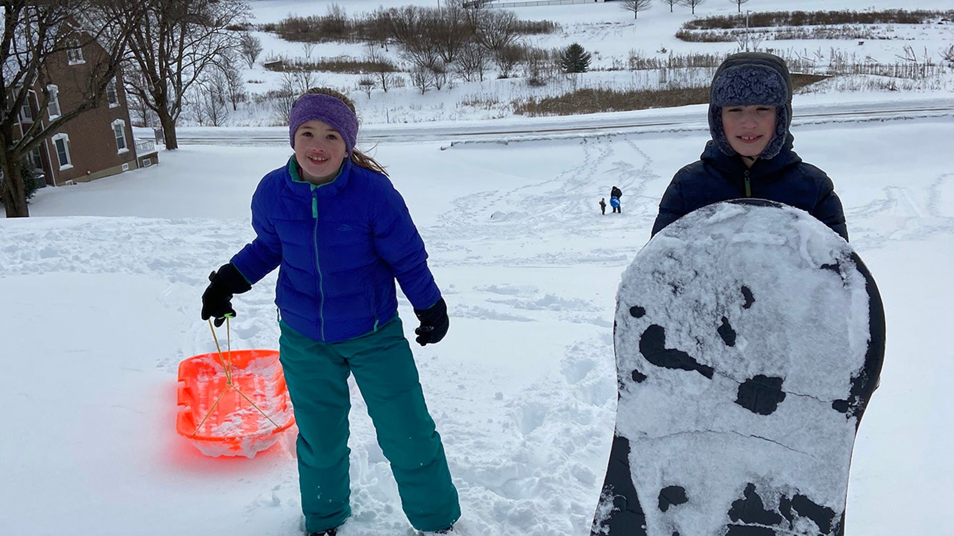 Siblings sledding at DeSales University in Center Valley, PA.