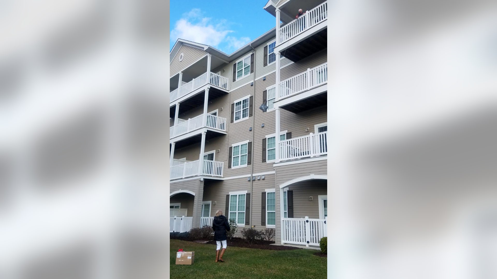 Since March my father has been in quarantine at his retirement home. At this point, he is in his room and cannot even go out into the hall. Every few days I try to take him something like a "happy meal" or a magazine or something to entertain him during his hours and hours alone. Several weeks ago I took a carrier bag filled with goodies and a 50 foot rope over to him and delivered it to the desk at the front to be delivered up to him. The rope, of course, was hidden in the bottom of the bag. I called him on the phone and told him that he must tie the rope to the bag and when I came we would use the bag for deliveries. Usually I have taken his stocking over about 11 PM on Christmas Eve and hung it on his door knob but since I can’t get in the building now to visit him or even drop things off we’ve been using the bag which he lowers from his fourth floor apartment down to the ground and I fill it with his goodies. This is a picture of me delivering his stocking and presents on Christmas morning you can see him over the edge of the balcony on the fourth level and me down on the ground and the bag of goodies on its way up to BILL. This has become one one of the highlights of his week that we both look forward. I feel like I’m delivering goodies to somebody in a treehouse. I get to see him and know how he is doing and he knows we love him and are thinking of him every day.