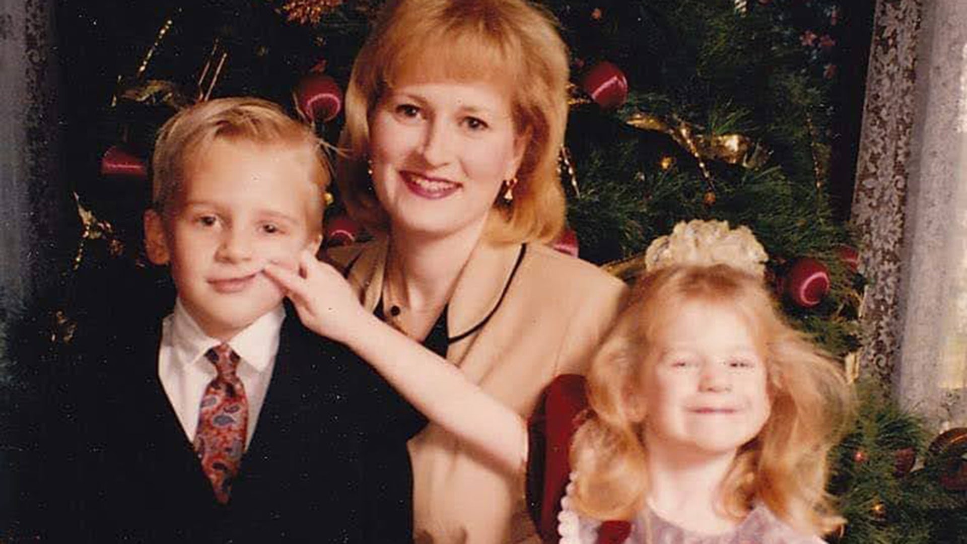This is my favorite Christmas Picture. My 5 year old son would not smile and my 3 year old daughter was a little fed up with him. So, she decided to make him smile right as her daddy snapped the picture. This was taken in the 90's so we didn't see it until the pictures were developed. Photo taken by Larry Deese Lora Deese Fairmont, WV