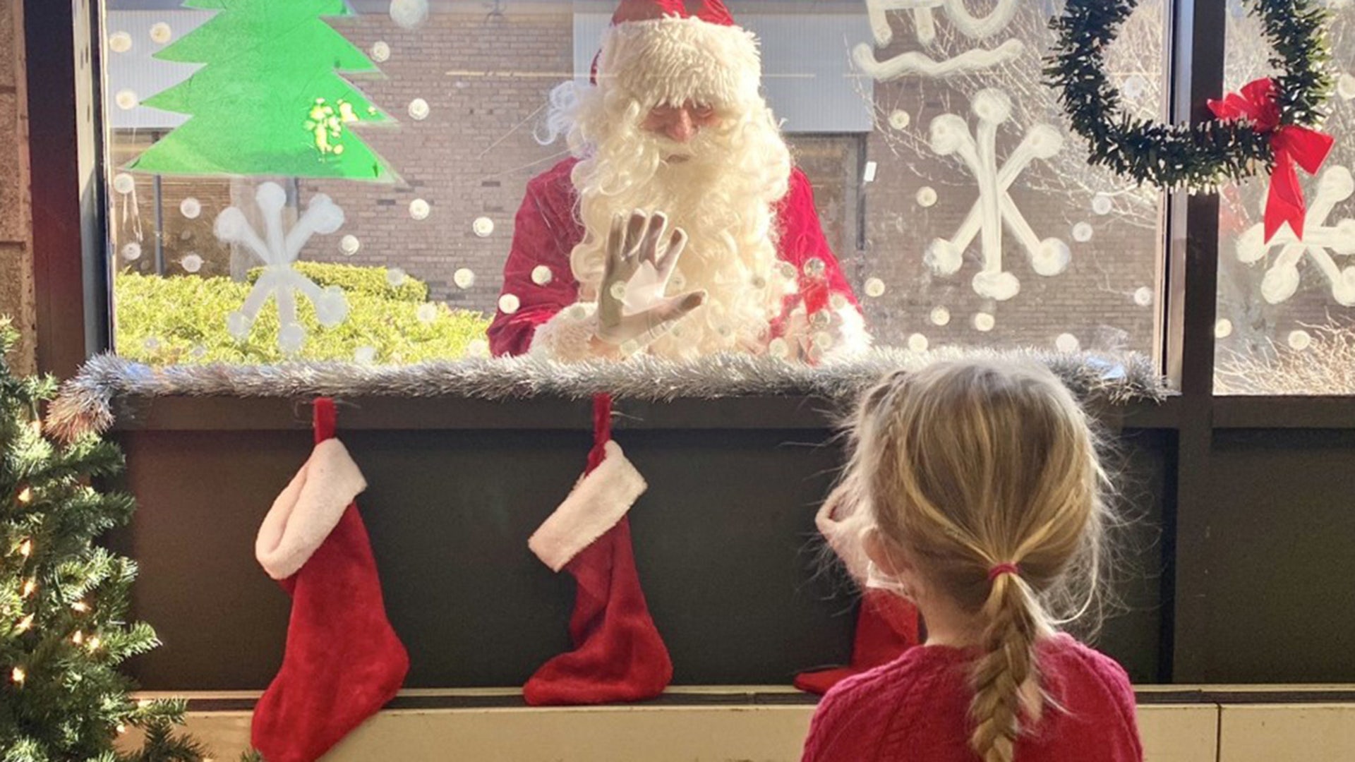 A photo of my daughter Maren McKenna at public school in plymouth,Ma. Santa visited the kids by looking in the classroom windows
