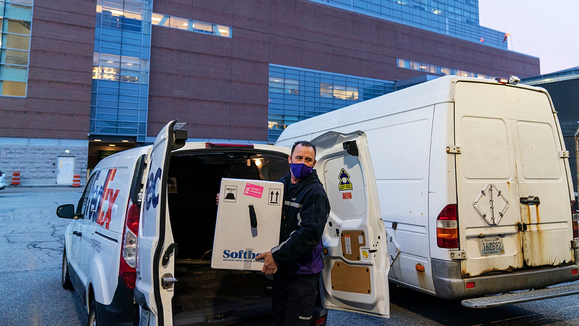 A FedEx driver delivers a box containing the Pfizer-BioNTech COVID-19 vaccine to Rhode Island Hospital in Providence, R.I., Monday, Dec. 14, 2020.