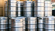 Australian woman wades through floodwaters to rescue beer kegs during extreme weather, video shows