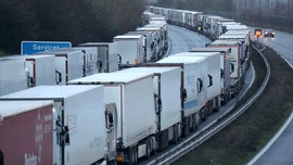 UK travel bans strand more than 1,500 France-bound trucks as governments work to reopen border