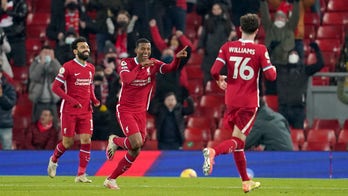 Spurs beat Arsenal to stay top, fans return to Anfield