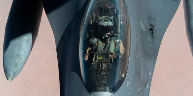 U.S. Air Force F-16 Fighting Falcon is aerial refueled by a KC-135 Stratotanker over the U.S. Central Command area of responsibility Dec. 30, 2020. The B-52 Stratofortress is a long-range, heavy bomber that is capable of flying at high subsonic speeds at altitudes of up to 50,000 feet and can carry nuclear or precision guided conventional ordnance with global reach precision navigation capability. (U.S. Air Force photo by Senior Airman Roslyn Ward)