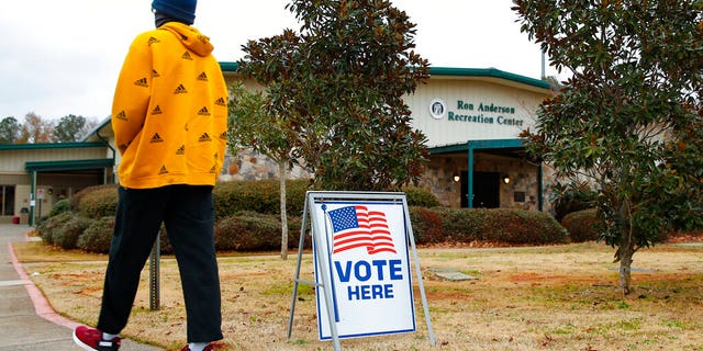 A voter walks to the entrance during early voting for the Senate runoff election, at Ron Anderson Recreation Center, Thursday, Dec. 17, 2020, in Powder Springs, Ga.