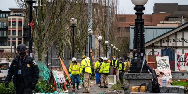 Seattle police arrested 21 people while crews cleared out a homeless encampment at Cal Anderson Park in December 2020.