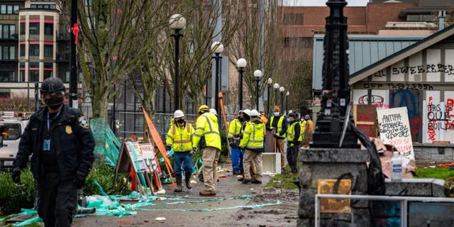 Seattle police arrested 21 people while crews cleared out a homeless encampment at Cal Anderson Park in December 2020.