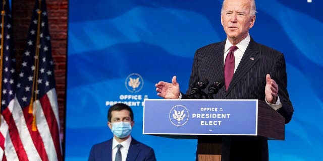 Former South Bend, Ind., Mayor Pete Buttigieg listens as President-elect Joe Biden announces Buttigieg as his nominee for transportation secretary during a news conference at The Queen theater in Wilmington, Del., Wednesday, Dec. 16, 2020. (Kevin Lamarque/Pool via AP)