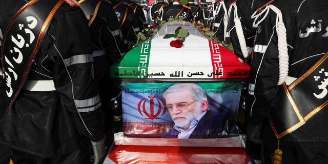 In this photo released by the official website of the Iranian Defense Ministry, military personnel stand near the flag-draped coffin of Mohsen Fakhrizadeh, a scientist who was killed on Friday, during a funeral ceremony in Tehran, Iran, Monday, Nov. 30, 2020. Fakhrizadeh founded Iran's military nuclear program two decades ago, and the Islamic Republic's defense minister vowed to continue the man's work "with more speed and more power." (Iranian Defense Ministry via AP)