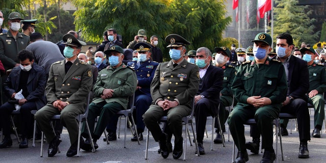 Military commanders attend a funeral ceremony of Mohsen Fakhrizadeh, a scientist who was killed on Friday, in a funeral ceremony in Tehran, Iran, Monday, Nov. 30, 2020. Iran held the funeral Monday for the slain scientist who founded its military nuclear program two decades ago, with the Islamic Republic's defense minister vowing to continue the man's work "with more speed and more power." (Iranian Defense Ministry via AP)