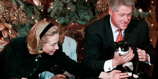 In this Dec. 20, 1996, file photo President Clinton holds Socks the cat as he and first lady Hillary Clinton host Washington area elementary school children at the White House where the president read "Twas the Night Before Christmas." (AP Photo/Ruth Fremson)