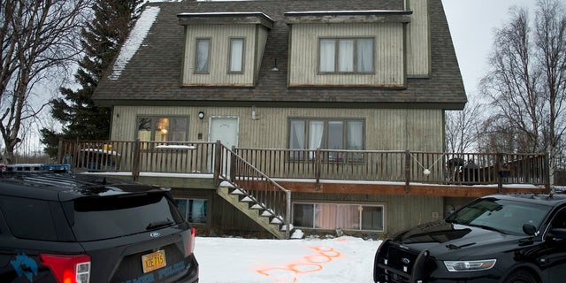 Alaska State Troopers investigate a fatal shooting scene at a home on North Valley Way in Palmer, Alaska on Monday. An 18-year-old Alaska man just out of jail for assaulting a family member has been charged with killing four members of his family, including two cousins under the age of 10, charging documents said. (Marc Lester/Anchorage Daily News via AP)