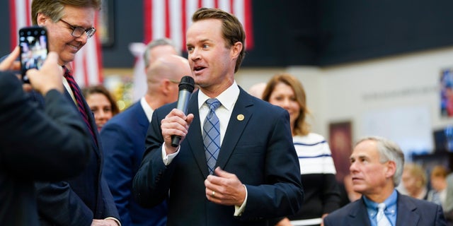 In this June 13, 2019 file photo, State Rep. Dade Phelan, center, R-Beaumont, talks to Lt. Gov. Dan Patrick before Gov. Greg Abbott signs Harvey-related measures at Gallery Furniture in Houston. (Elizabeth Conley/Houston Chronicle via AP, File)