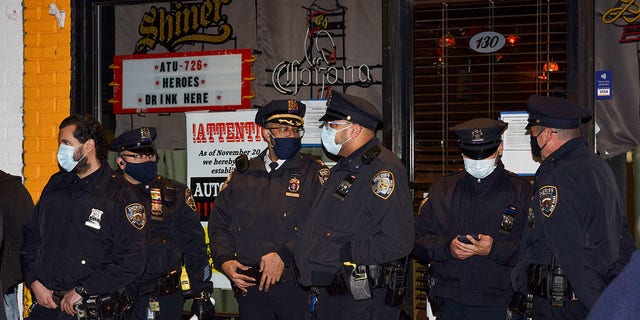 New York sheriff's deputies stand outside Mac's Public House after co-owner Danny Presti was arrested on Tuesday, December 1, 2020 in New York State District.  (Associated Press)