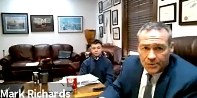 In this screen grab from live stream video, Kyle Rittenhouse, left, appears with his attorney, Mark Richards during a hearing at Kenosha County Court in Kenosha, Wis., on Dec. 3, 2020. A court commissioner has ruled that there is sufficient evidence to warrant a trial for the Illinois teenager accused of killing two men during an August protest in Wisconsin. (Kenosha County Court/ AP)