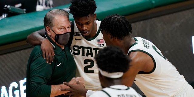 Michigan State coach Tom Izzo talks to guard Rocket Watts and forward Aaron Henry during the second half of the team's NCAA college basketball game against Detroit Mercy, Friday, Dec. 4, 2020, in East Lansing, Mich.