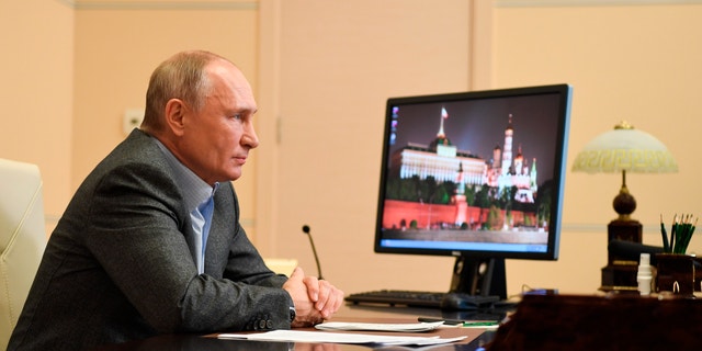 Russian President Vladimir Putin attends a meeting with participants of the We Are Together nationwide volunteer campaign via video conference at the Novo-Ogaryovo residence outside Moscow, Russia, Saturday, Dec. 5, 2020. (Alexei Nikolsky, Sputnik, Kremlin Pool Photo via AP)