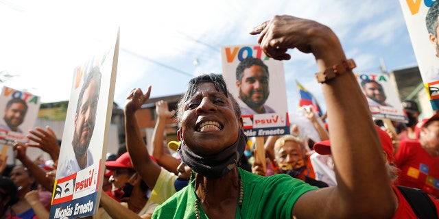 Supporters of Nicolas Maduro Guerra, the only son of Venezuela's President Nicolas Maduro, cheer at a rally for the 30-year-old politico — commonly called “Nicolasito,” or “Little Nicolás”, in Maiquetía, Venezuela, Sunday, Nov. 29, 2020. (AP Photo/Ariana Cubillos)