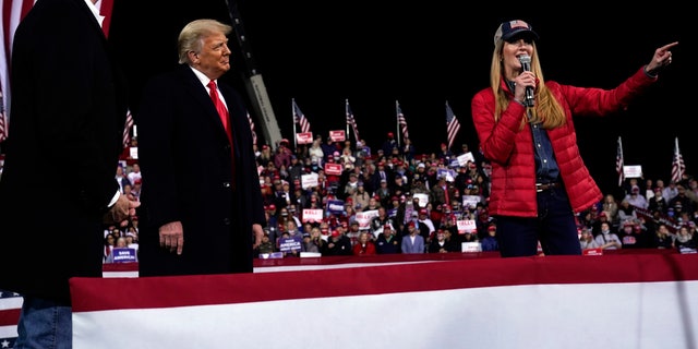 Sen. Kelly Loeffler, R-Ga., speaks as President Trump and Sen. David Perdue, R-Ga., listen at a campaign rally at Valdosta Regional Airport, Dec. 5, 2020, in Valdosta, Ga. (AP Photo/Evan Vucci)