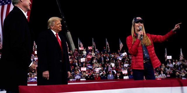 Sen. Kelly Loeffler, R-Ga., speaks as President Trump and Sen. David Perdue, R-Ga., listen at a campaign rally at Valdosta Regional Airport, Saturday, Dec. 5, 2020, in Valdosta, Ga. (AP Photo/Evan Vucci)