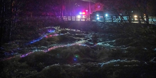 Ketchikan police and emergency response personnel deliver evacuation warnings to residents within a flood evacuation area that borders Ketchikan Creek, Saturday, Dec. 5, 2020, in Ketchikan, Alaska. (Dustin Safranek/Ketchikan Daily News via AP)