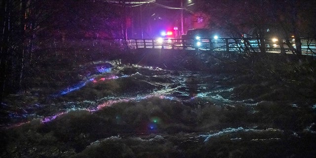 Ketchikan police and emergency response personnel deliver evacuation warnings to residents within a flood evacuation area that borders Ketchikan Creek, Saturday, Dec. 5, 2020, in Ketchikan, Alaska. (Dustin Safranek/Ketchikan Daily News via AP)