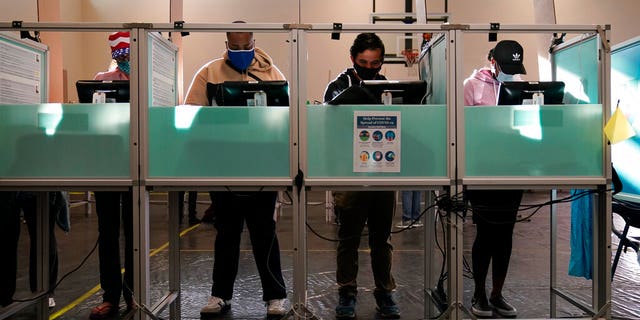 People vote at a polling place on Election Day, in Las Vegas.