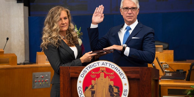 Incoming Los Angeles County District Attorney George Gascon is sworn in as his wife Fabiola Kramsky holds a copy of the Constitution on Dec. 7. (Bryan Chan/County of Los Angeles via AP)