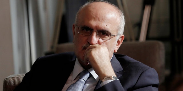 In this May 24, 2019 file photo, then-Lebanese Finance Minister Ali Hassan Khalil listens to Lebanese Information Minister Jamal Jarrah while he speaks to a journalist at the Government House in Beirut, Lebanon. (AP Photo/Hassan Ammar, File)