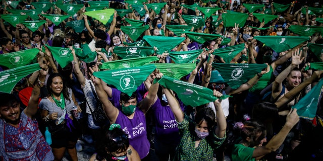 Abortion-rights activists rally outside Congress as lawmakers debate a bill on its legalization, in Buenos Aires, Argentina, Thursday, Dec. 10, 2020. The lower house is expected to vote on a legal abortion bill presented by President Alberto Fernández. (AP Photo/Natacha Pisarenko)