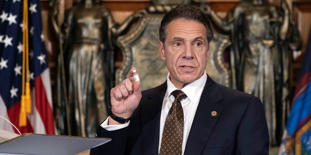 In this Dec. 3, 2020, photo provided by the Office of Gov. Andrew Cuomo, Cuomo holds up samples of empty packaging for the COVID-19 vaccine during a news conference in the Red Room at the State Capitol in Albany, N.Y.  (Mike Groll/Office of Governor of Andrew M. Cuomo via AP)