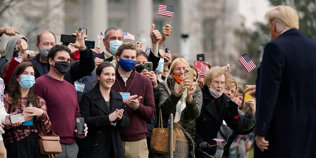 Supporters greeet President Donald Trump as he walks on the South Lawn of the White House in Washington, Saturday, Dec. 12, 2020, before boarding Marine One. (Associated Press)