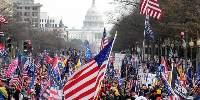 With the U.S. Capitol building in the background, supporters of President Donald Trump stand Pennsylvania Avenue during a rally at Freedom Plaza, Saturday, Dec. 12, 2020, in Washington. (Associated Press)