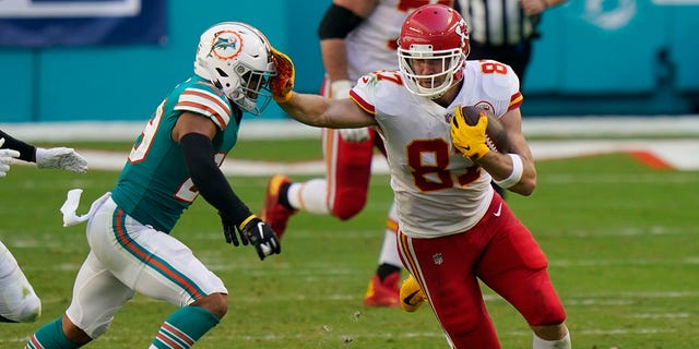 Kansas City Chiefs tight end Travis Kelce (87) stops Miami Dolphins free safety Brandon Jones (29), during the first half of an NFL football game, Sunday, Dec. 13, 2020, in Miami Gardens, Fla. (AP Photo/Lynne Sladky)