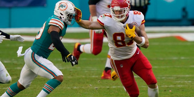 Kansas City Chiefs tight end Travis Kelce (87) stops Miami Dolphins free safety Brandon Jones (29), during the first half of an NFL football game, Sunday, Dec. 13, 2020, in Miami Gardens, Fla. (AP Photo/Lynne Sladky)
