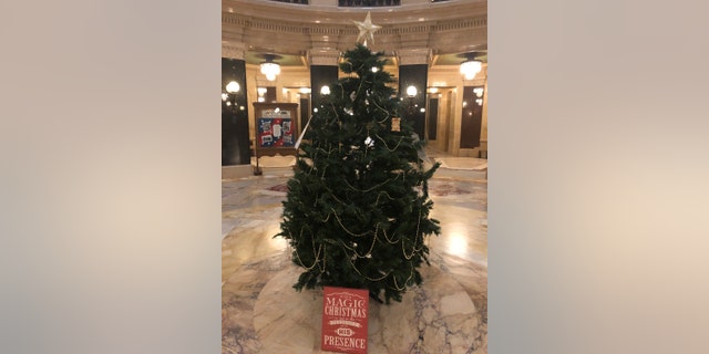 In this Dec. 7, 2020 file photo, an artificial Christmas tree that two Republican lawmakers set up stands in the Wisconsin Capitol rotunda in Madison, Wis. The tree was removed Tuesday, Dec. 15, 2020, because the lawmakers did not have a permit and they refused to move it to an area where it could be displayed. (AP Photo/Todd Richmond, File)