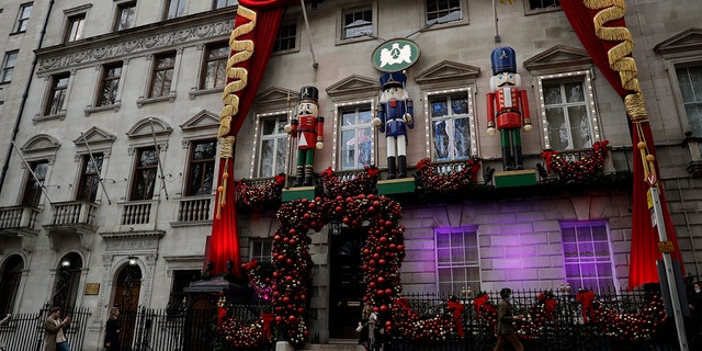 Christmas decorations are displayed on the facade of the Annabel's private members club in Berkeley Square, Mayfair, London, Wednesday, Dec. 16, 2020. London and some of its surrounding areas have been placed under Britain's highest level of coronavirus restrictions beginning at 00:01 local time on Wednesday as infections rise rapidly in the capital. Under Tier 3 restrictions, the toughest level in England's three-tier system, people can't socialize indoors, and bars, pubs and restaurants must close except for takeout. (AP Photo/Matt Dunham)