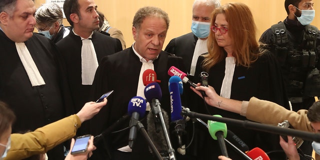 Plaintiffs' lawyer Mehana Mouhou, center, answers reporters after the verdict in the January 2015 Paris attacks trial, Wednesday, Dec.16, 2020, in Paris. The fugitive widow of an Islamic State gunman and a man described as his logistician on Wednesday were convicted of terrorism charges in the trial of 14 people linked to the January 2015 attacks in Paris against the satirical Charlie Hebdo newspaper and a kosher supermarket. The verdict ends the three-month trial linked to the three days of killings across Paris claimed jointly by the Islamic State group and al-Qaida. (AP Photo/Michel Euler)