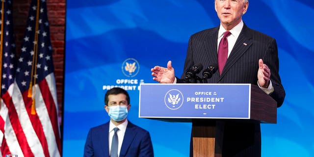 Dec 16, 2020: Former South Bend, Ind. Mayor Pete Buttigieg listens as President-elect Joe Biden announces Buttigieg as his nominee for transportation secretary during a news conference at The Queen theater in Wilmington, Del., (Kevin Lamarque/Pool via AP).